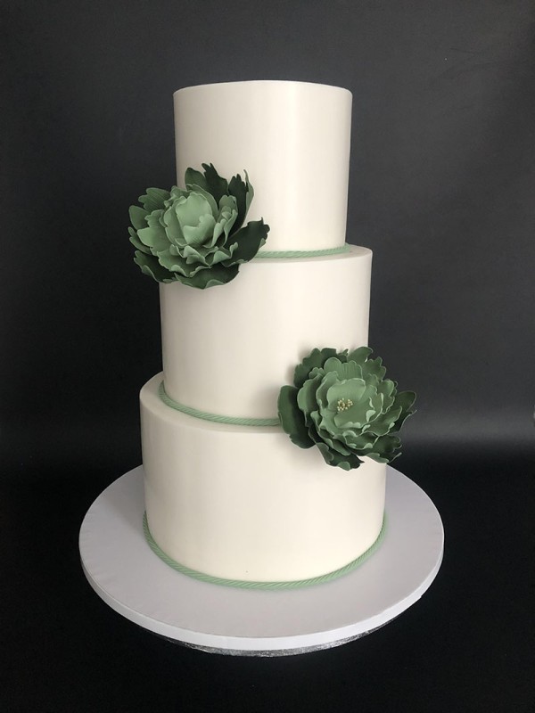 Green and white fondant wedding cake with sugar flowers