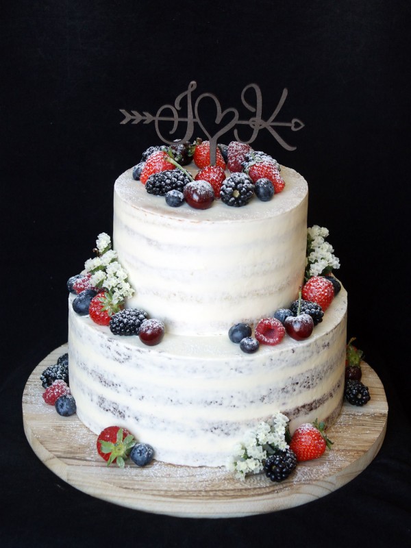 Semi-naked wedding cake with fresh berries