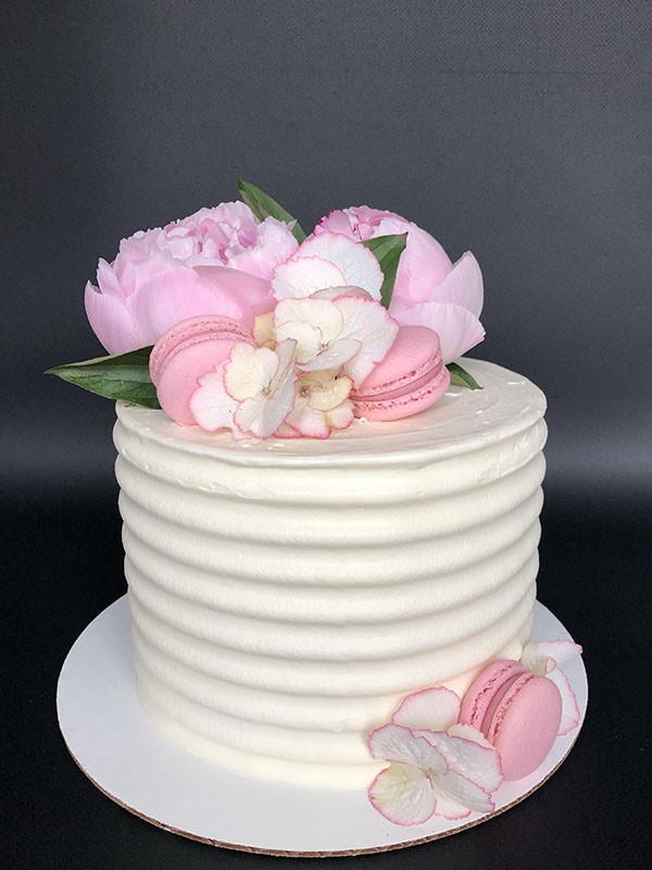 White wedding cake with pink decorations