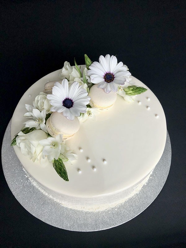 Mousse wedding cake with macarons and flowers