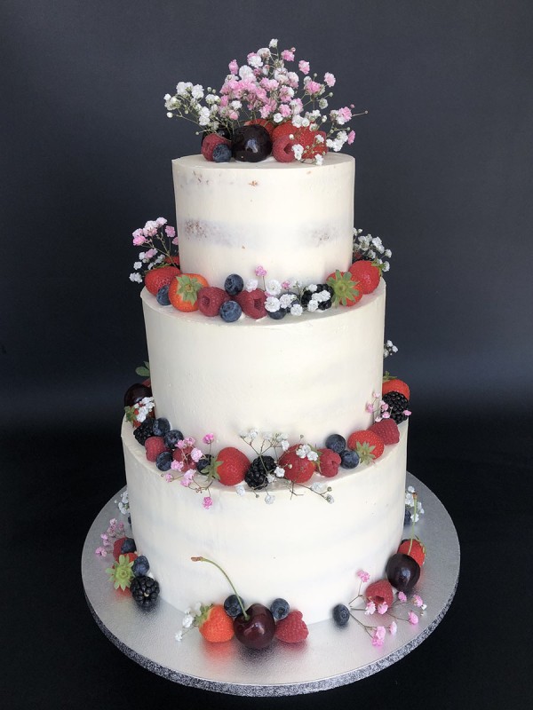Semi-naked wedding cake with berries