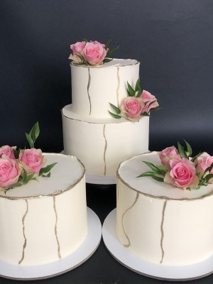 Trio wedding cake with gold and roses